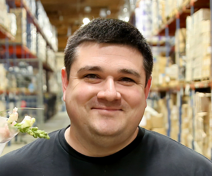 man in warehouse smiling